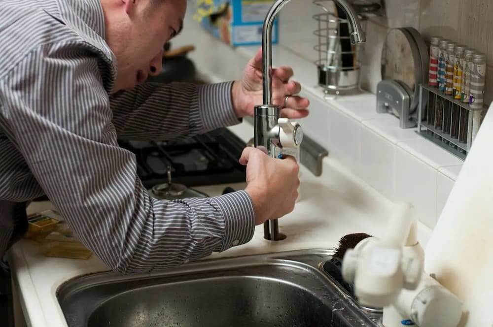 Plumber fixing sink