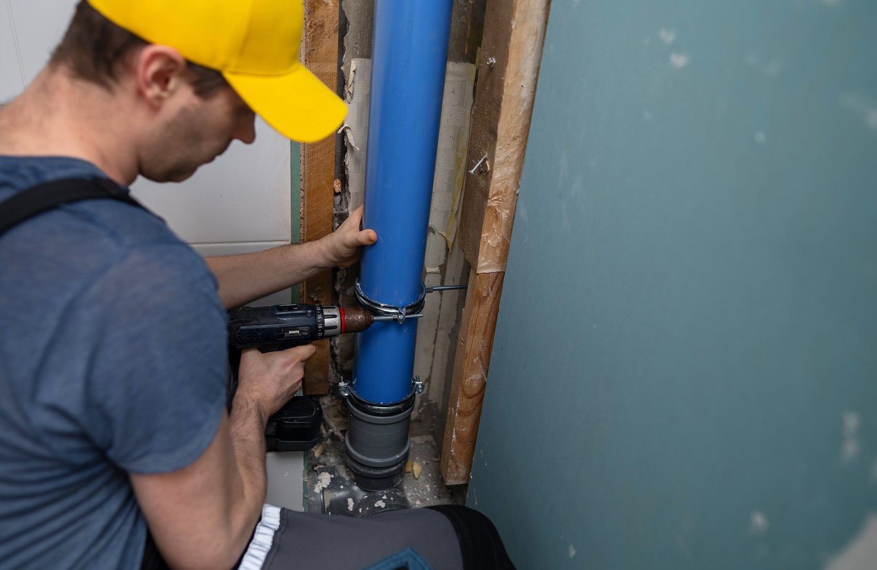 A man installing a new sewer drain